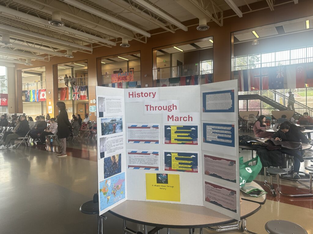 March 2025 history board displayed on a table in a school common area