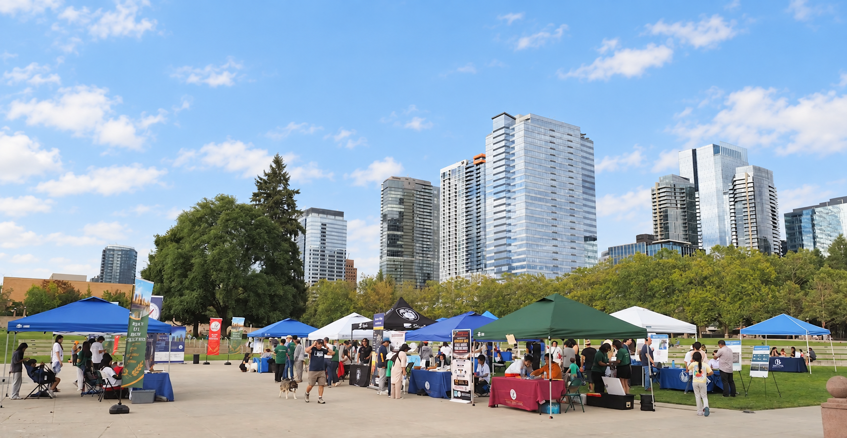 Community booths and visitors at the Bellevue Local History Celebration, with the downtown skyline behind them